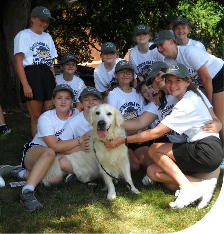 Cadets gathered and posing around a dog